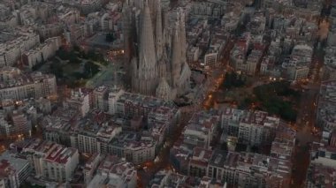 Aerial view of Barcelona City Skyline and Sagrada Familia Cathedral. Residential famous urban grid. Beautiful cityscape with typical urban octagon blocks