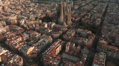 Aerial view of Barcelona City Skyline and Sagrada Familia Cathedral. Residential famous urban grid. Beautiful cityscape with typical urban octagon blocks
