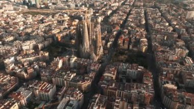 Aerial view of Barcelona City Skyline and Sagrada Familia Cathedral. Residential famous urban grid. Beautiful cityscape with typical urban octagon blocks