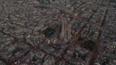 Aerial view of Barcelona City Skyline and Sagrada Familia Cathedral. Residential famous urban grid. Beautiful cityscape with typical urban octagon blocks