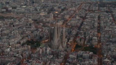 Aerial view of Barcelona City Skyline and Sagrada Familia Cathedral. Residential famous urban grid. Beautiful cityscape with typical urban octagon blocks