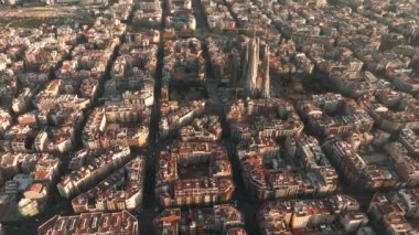 Aerial view of Barcelona City Skyline and Sagrada Familia Cathedral. Residential famous urban grid. Beautiful cityscape with typical urban octagon blocks