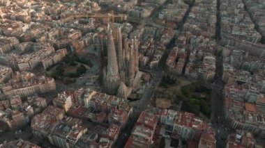 Aerial view of Barcelona City Skyline and Sagrada Familia Cathedral. Residential famous urban grid. Beautiful cityscape with typical urban octagon blocks