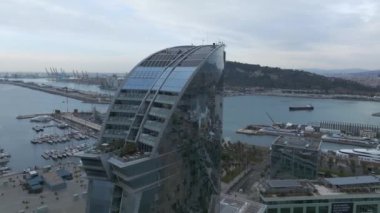 View of the Barceloneta beach with luxury hotel W Barcelona by the sea shore. Beautiful luxury hotel in Barcelona.