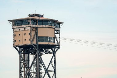 Low angle view of Torre Sant Sebastia a aerial tramway with cables and restaurant on top of tower with clear sky in the background at Catalonia in Barcelona, Spain