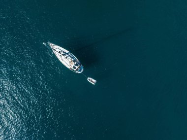 Aerial view of yacht in deep blue sea by the Gran Canaria coastline. Amazing view of luxury yachts sailing in open sea on a calm day.