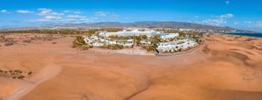 Panoramic aerial scene of the Maspalomas Dunes in Playa del Ingles, Maspalomas, Gran Canaria, Spain. Endless desert sands. Magical safari dunes.