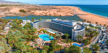 Beautiful luxury hotel concept. Holidays in Spain in a fabulous hotel with infinity pool and near by beach line. Aerial cinematic view.