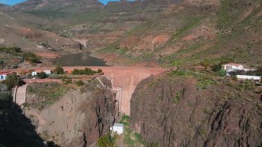 Artificial lake water dam in the Canary Islands at Gran Canaria. Aerial view of the Dam holding the water.