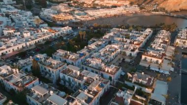 Puerto de Mogan fishing town aerial view at sunset. Traditional colorful buildings with many fishing boats at Gran Canaria, Canary Islands, Spain
