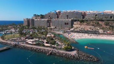 Beautiful aerial landscape with Anfi beach and resort, Gran Canaria, Spain. Luxury hotels, turquoise water, sandy beaches in Spain. Luxury beach vacation concept. Heart shaped island.