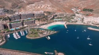 Beautiful aerial landscape with Anfi beach and resort, Gran Canaria, Spain. Luxury hotels, turquoise water, sandy beaches in Spain. Luxury beach vacation concept. Heart shaped island.