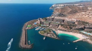 Beautiful aerial landscape with Anfi beach and resort, Gran Canaria, Spain. Luxury hotels, turquoise water, sandy beaches in Spain. Luxury beach vacation concept. Heart shaped island.