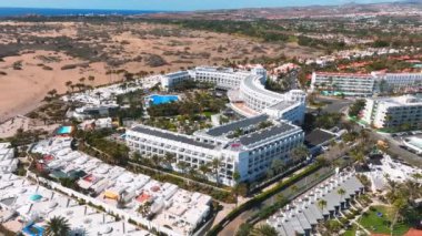 Beautiful luxury hotel concept. Holidays in Spain in a fabulous hotel with infinity pool and near by beach line. Aerial cinematic view.