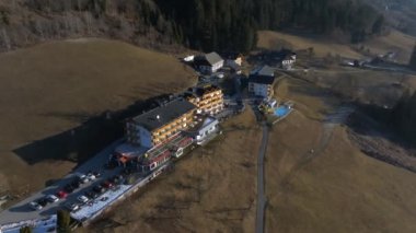 Beautiful luxury Alpine hotel on top of the mountain during spring time. Holiday concept view.