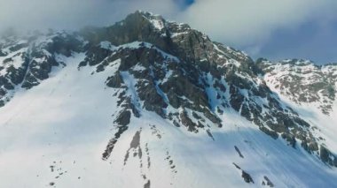 Tepeleri kar ve bulutlarla kaplı dağlık bir arazi. Ünlü St. Anton am Arlberg kayak merkezindeki dağların zirvelerini kaplayan sihirli bulutlar.