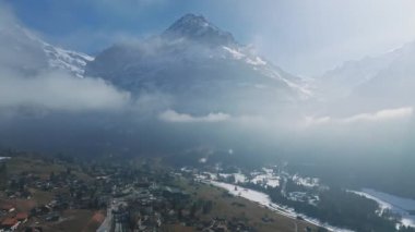İsviçre 'nin Grindelwald, İsviçre köyü manzarası İsviçre Alpleri yakınlarındaki panorama manzarası, yeşil tarlalarda ahşap kiremitler ve arka planda yüksek zirveler, Bernese Oberland, Avrupa.