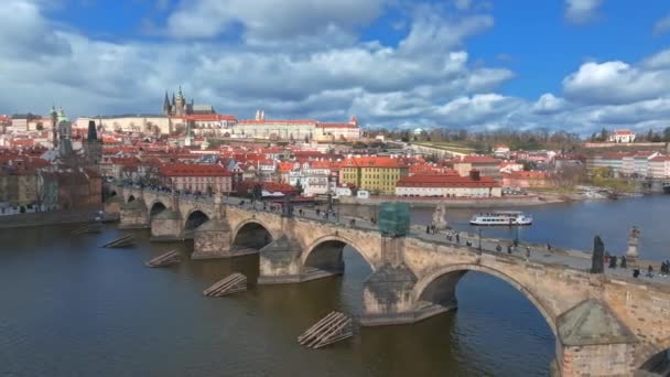 チェコ共和国プラハのヴルタヴァ川にかかる旧市街の桟橋建築とカレル橋の絶景の春のパノラマ — ストック動画