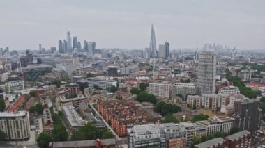 Aerial view of the City of London Shard. High quality 4k footage. Aerial view of London with The Shard skyscraper and Thames river at sunset with grey clouds in the sky