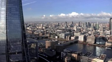 Aerial view of the City of London Shard. High quality 4k footage. Aerial view of London with The Shard skyscraper and Thames river at sunset with grey clouds in the sky