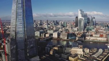 Aerial view of the City of London Shard. High quality 4k footage. Aerial view of London with The Shard skyscraper and Thames river at sunset with grey clouds in the sky