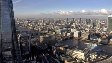 Aerial view of the City of London Shard. High quality 4k footage. Aerial view of London with The Shard skyscraper and Thames river at sunset with grey clouds in the sky