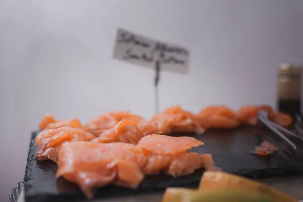 A simple and straightforward presentation of a plate of salmon and other food. The salmon is arranged in the center of the plate, creating an appealing visual composition.
