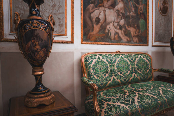 Luxurious living room interior with elegant couch and artwork on the wall. Classic and stylish home decor with comfortable seating. Ideal for interior design, home decor, and lifestyle concepts.