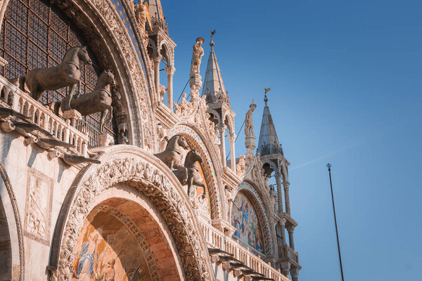 Explore the serene beauty of Venice with a stunning image of the citys cathedral. The peaceful atmosphere and clear blue sky make for a captivating view.
