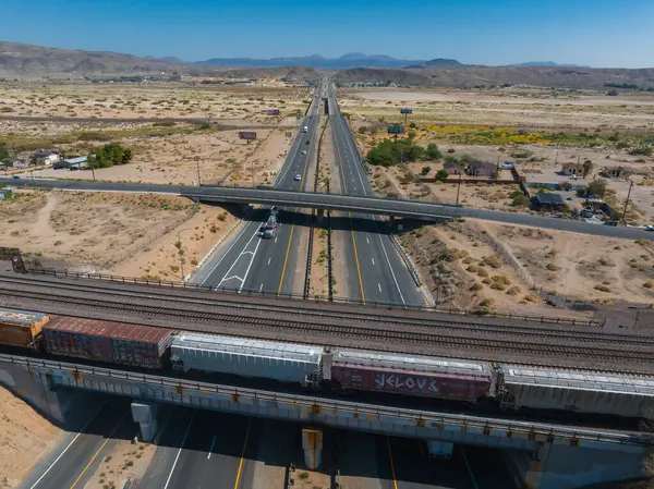 Aerial View Sunlit Highway Interchange Parallel Train Tracks Desert Landscape — Stock Photo, Image