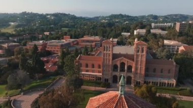 UCLA kampüsünün havadan görünüşü Royce Hall 'un merkez sahnesi, Romanesk mimarisi, yeşil alanlar, ve Westwood kentsel zemin altın sabah - öğleden sonra ışığı.