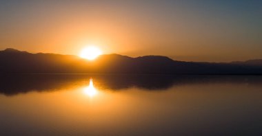 Kaliforniya 'daki Salton Denizi üzerinde hava manzarası. Gün batımında çölün ortasında kocaman bir göl..