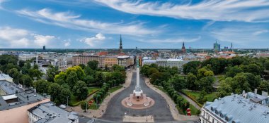 Özgürlük heykelinin yanında Riga 'nın üzerinde güzel bir gün doğumu manzarası var Letonya' da Milda. Özgürlük Anıtı.