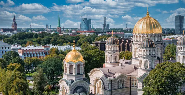 Riga, Letonya 'daki İsa' nın Doğumu Katedrali. Bizans tarzı Ortodoks katedrali, Baltık bölgesinin en büyüğü, altın renkli kubbesi, ağaçların arasında parıldayan yaldızlı kubbeleri var.