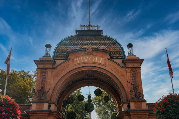 Entrance Copenhagens Tivoli Gardens Tivoli Atop Red Brick Archway Adorned — Stock Photo, Image
