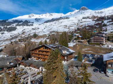 İsviçre 'deki Verbier kayak merkezinin hava panoramik manzarası. Dağların önünde duran klasik ahşap dağ evleri.. 
