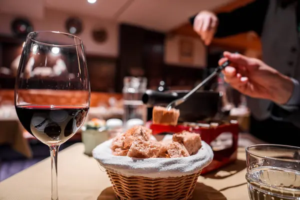 Intimate Dining Scene Red Wine Bread Basket Fondue Pot Person — Stock Photo, Image