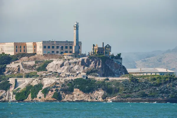 stock image Distant view of Alcatraz Island in San Francisco Bay, USA, known for the infamous former Alcatraz Federal Penitentiary. Rocky terrain, lighthouse, and maritime activities.