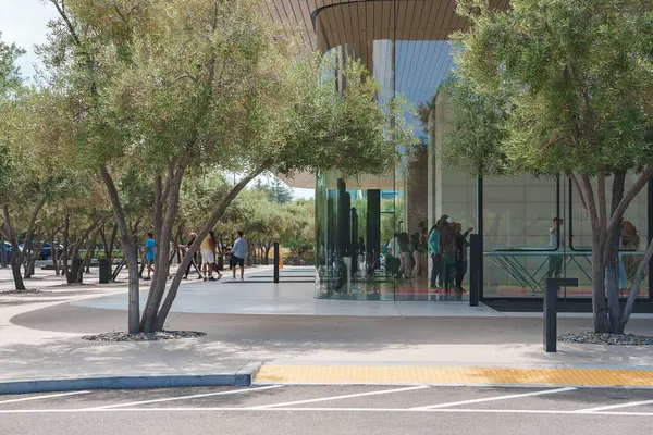 stock image Modern Apple Store exterior with glass panels and wooden overhang near Apple office complex, Mountain View, CA. Customers shopping for Apple products.