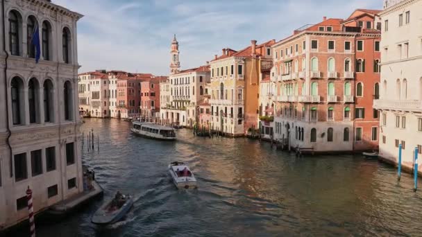 ヴェネツィアのゴンドラをヴェネツィア イタリアのグリーン運河の水路を通してゴンドラを貫くヴェネツィアのサニエ 日没のロマンチックな黄金の夜ライトで有名なカナルグランデの伝統的なゴンドラの美しい景色 — ストック動画