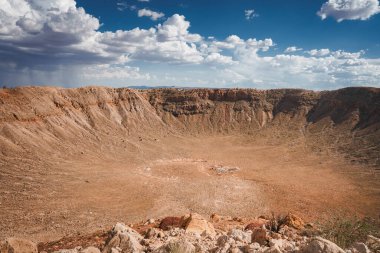 Impressive Meteor Crater, Barringer Crater, Arizona, USA. A geological landmark formed by a meteorite impact 50,000 years ago. Arid desert terrain, steep walls, sparse vegetation. clipart