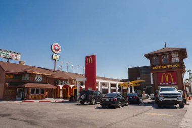 Sunny day in Barstow, USA on Route 66. McDonalds restaurant with red and yellow sign, Southwestern architecture. Commercial area with iconic Americana vibe. clipart