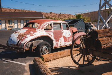 Vintage Volkswagen Beetle parked in a desert setting resembling Barstow, USA. Weathered red and white paint, rustic charm, historical ambiance, nostalgic Route 66 vibe. clipart