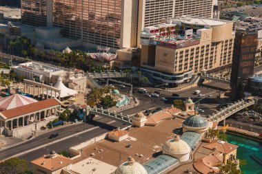 Aerial view of bustling Las Vegas Strip during the day with luxurious architecture, palm trees, and dense structures, showcasing citys entertainment vibe. clipart