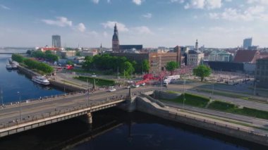 Riga Rimi Maratonu 2024. Maraton etkinliği sırasında şehirde koşan kalabalığın hava görüntüsü. Toprak setten başlayın ve insanlar Daugava nehrinden şehir merkezine doğru koşun..