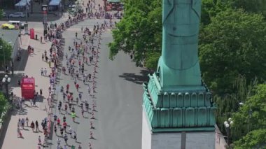 Riga Rimi Maratonu 2024. Maraton etkinliği sırasında şehirde koşan kalabalığın hava görüntüsü. Toprak setten başlayın ve insanlar Daugava nehrinden şehir merkezine doğru koşun..