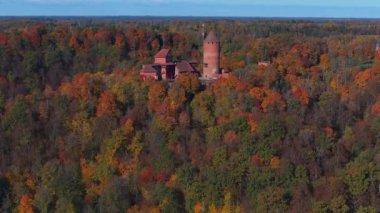 Letonya, Sigulda 'daki Turaida Kalesi' ni çevreleyen canlı sonbahar renklerini ortaçağ mimarisini vurgulayan havadan bir perspektifle keşfedin..