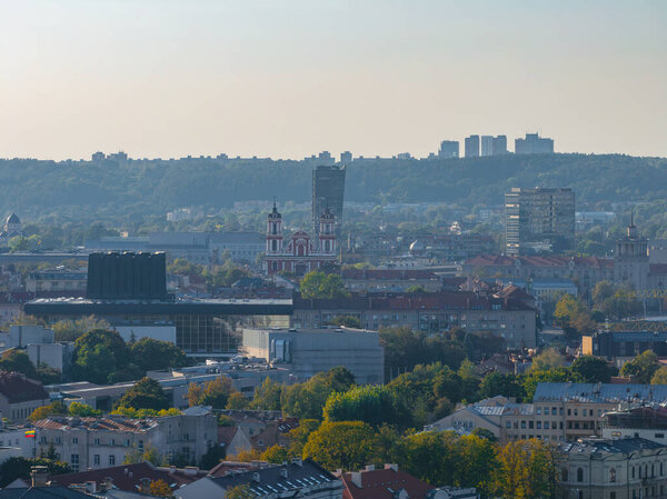 Aerial view of Vilnius, Lithuania, highlighting the Church of St. Philip and St. Jacob amidst a blend of modern and historical architecture.