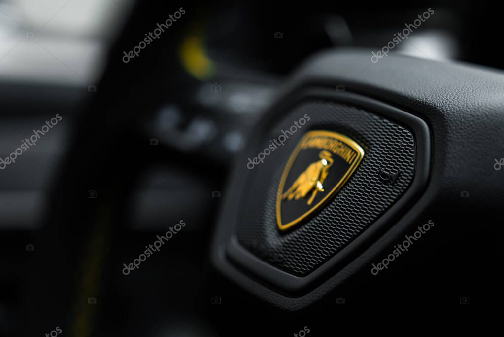 Detailed view of the Lamborghini logo on the Urus Performante steering wheel, highlighting the texture and craftsmanship of the luxury interior.