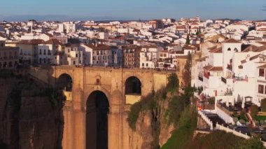 Puente Nuevo köprüsünün yer aldığı Ronda, İspanya hava manzarası. Günbatımında, beyazlatılmış binalar ve dramatik uçurumlar üzerinde altın rengine bürünür.